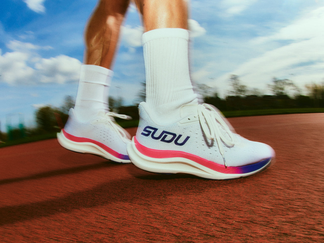 White SUDU running shoes on the running track